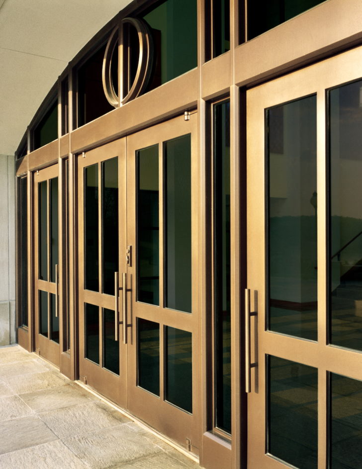 DAWSON Custom Series Balanced doors brass entrance with vaulted custom transom.